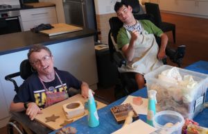 Two Rocky Bay customers are enjoying doing pottery at one of our Guest Houses - The Bush Retreat.