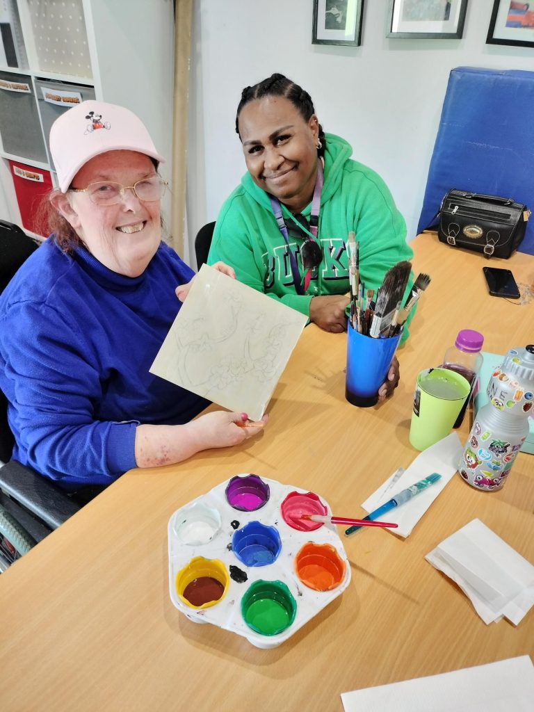 Rocky Bay customer and support worker during a painting workshop.