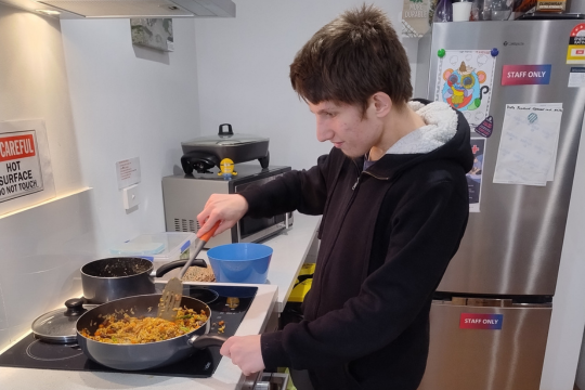 Liam cooking over the stove.